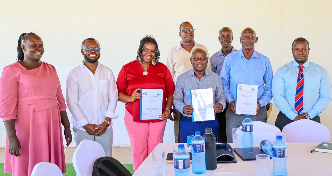 Partners holding signed agreements after a signing meeting